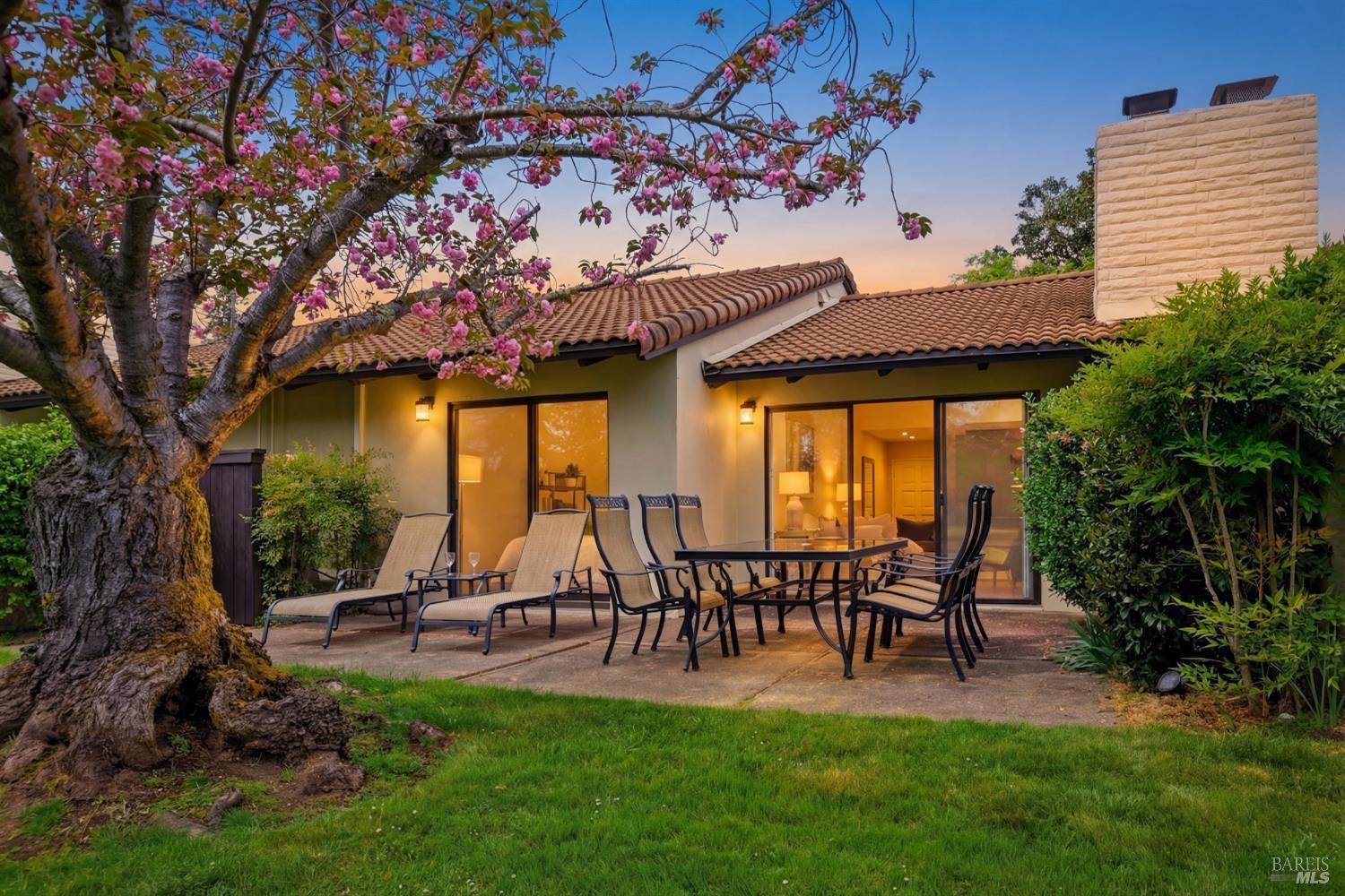 13 Fairways Drive at The Fairways at Silverado, Napa, rear patio and lawn at twilight — listed by The Magliocco Group