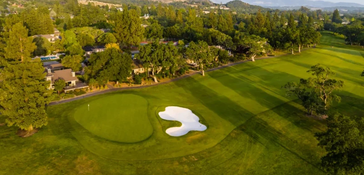 Aerial view of a Silverado golf course green and white sand bunker, framed by oaks with homes along the fairway